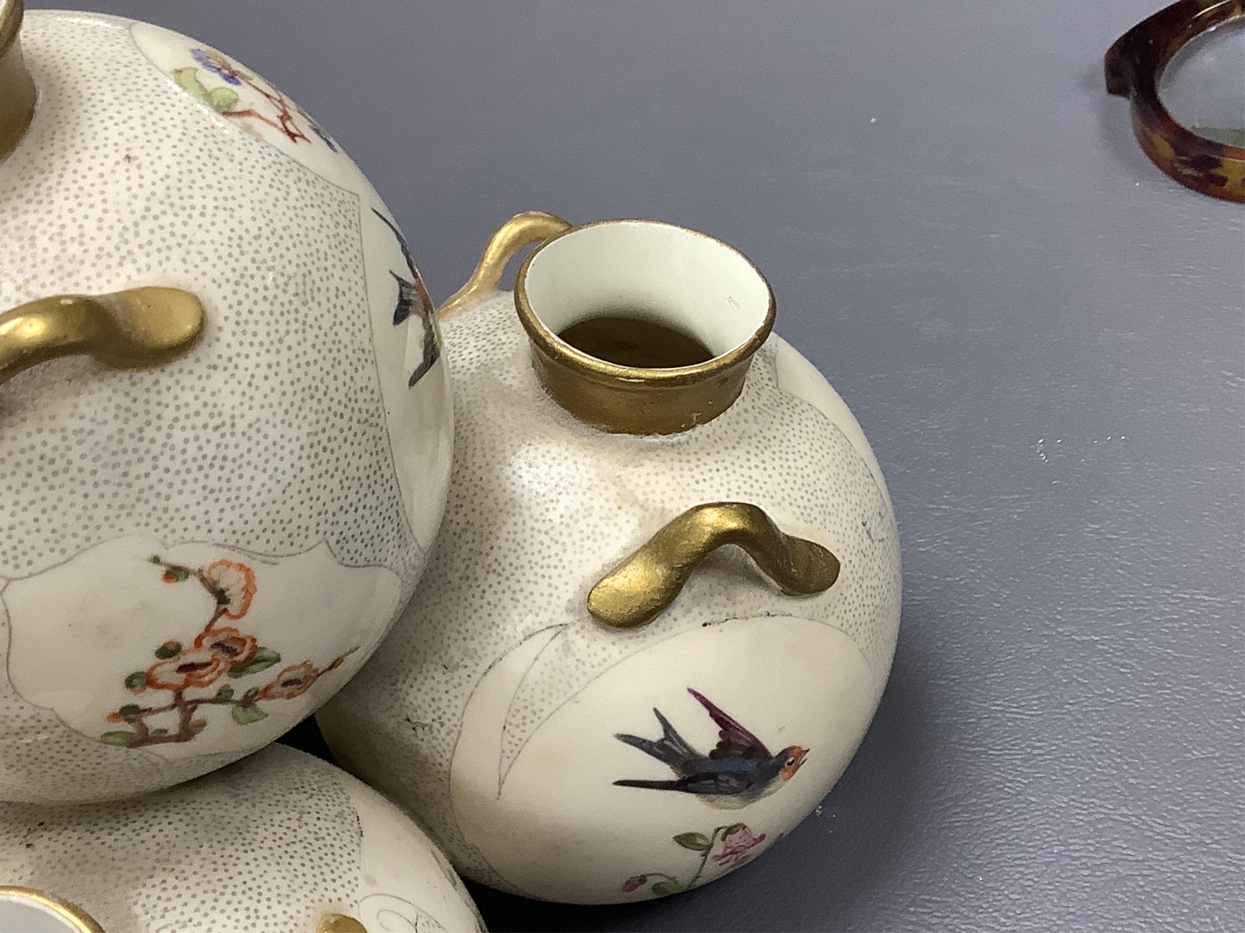 Three Royal Worcester 'pyramid' vases, painted with birds, 14cm high. Condition - fair/good